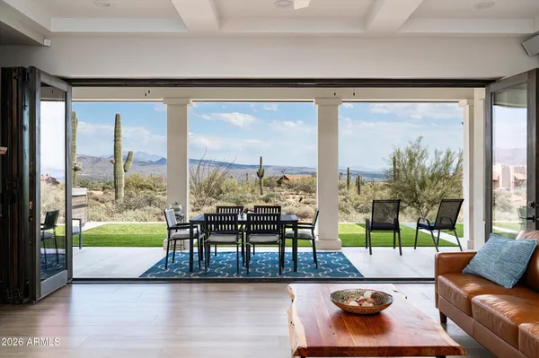 a living room with furniture and a floor to ceiling window