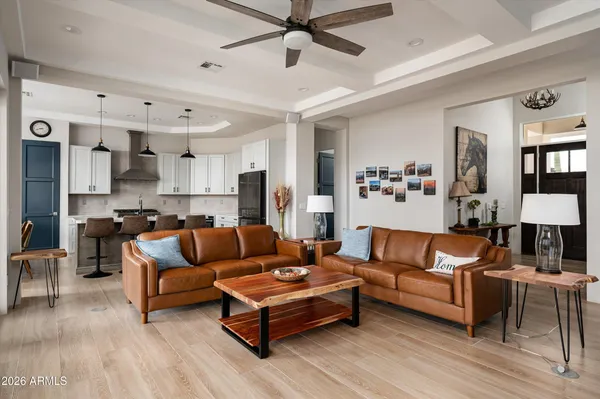 a living room with furniture and a view of kitchen