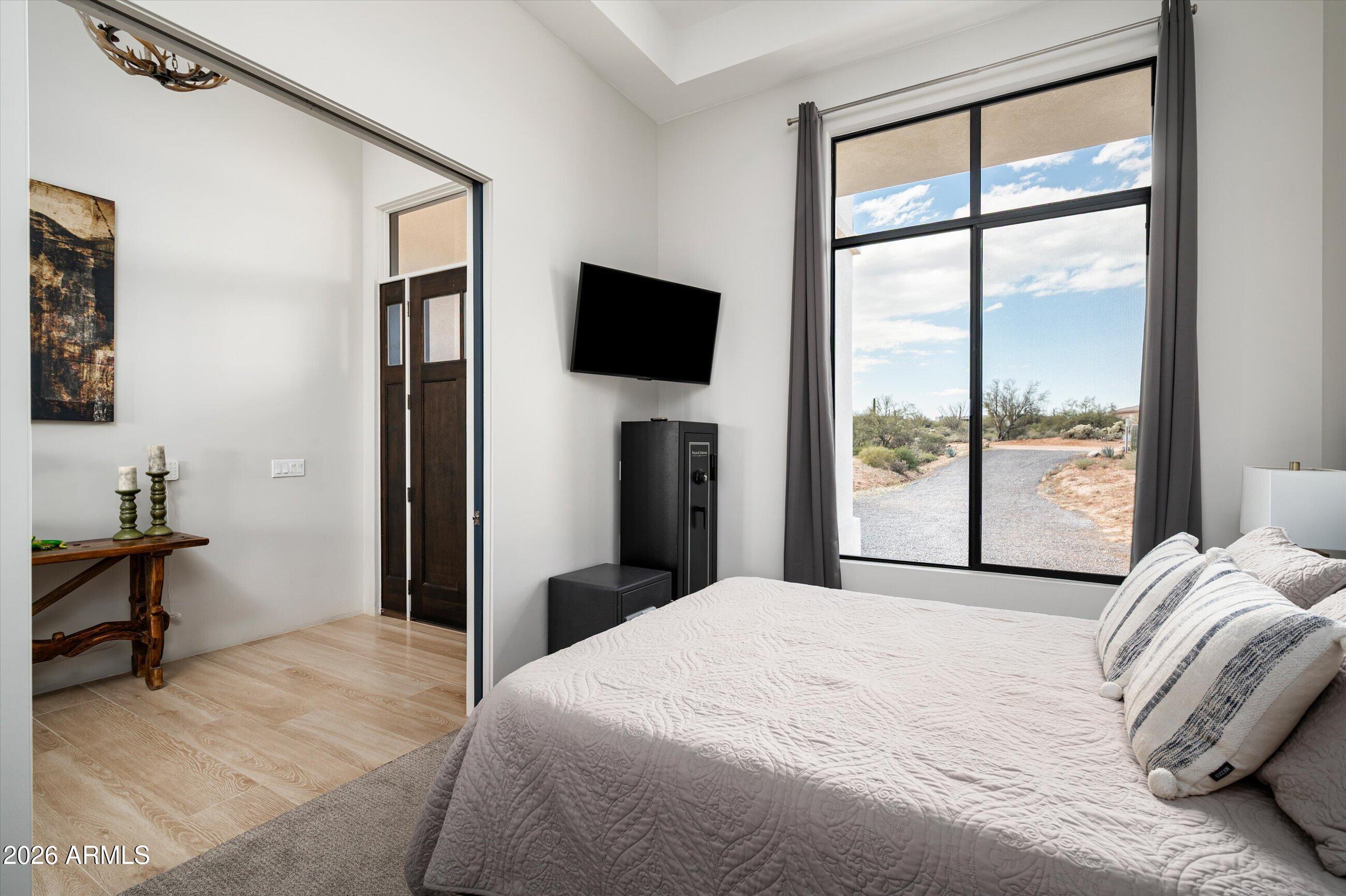 17439 East Wildcat Drive Rio Verde, AZ 85263 - Photo 10 of 25 a bedroom with a bed and a flat tv screen next to a window
