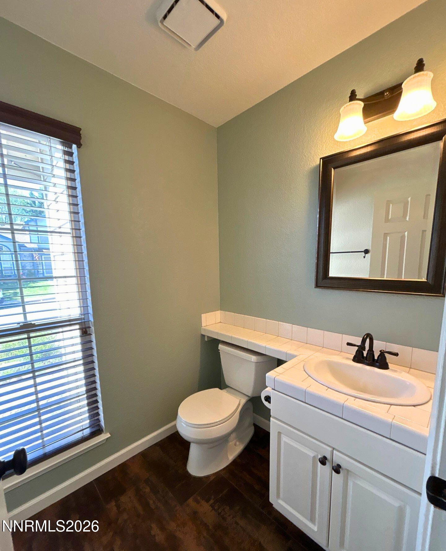 4437 Highplains Drive Reno, NV 89523 - Photo 10 of 19 a bathroom with a toilet a sink and mirror