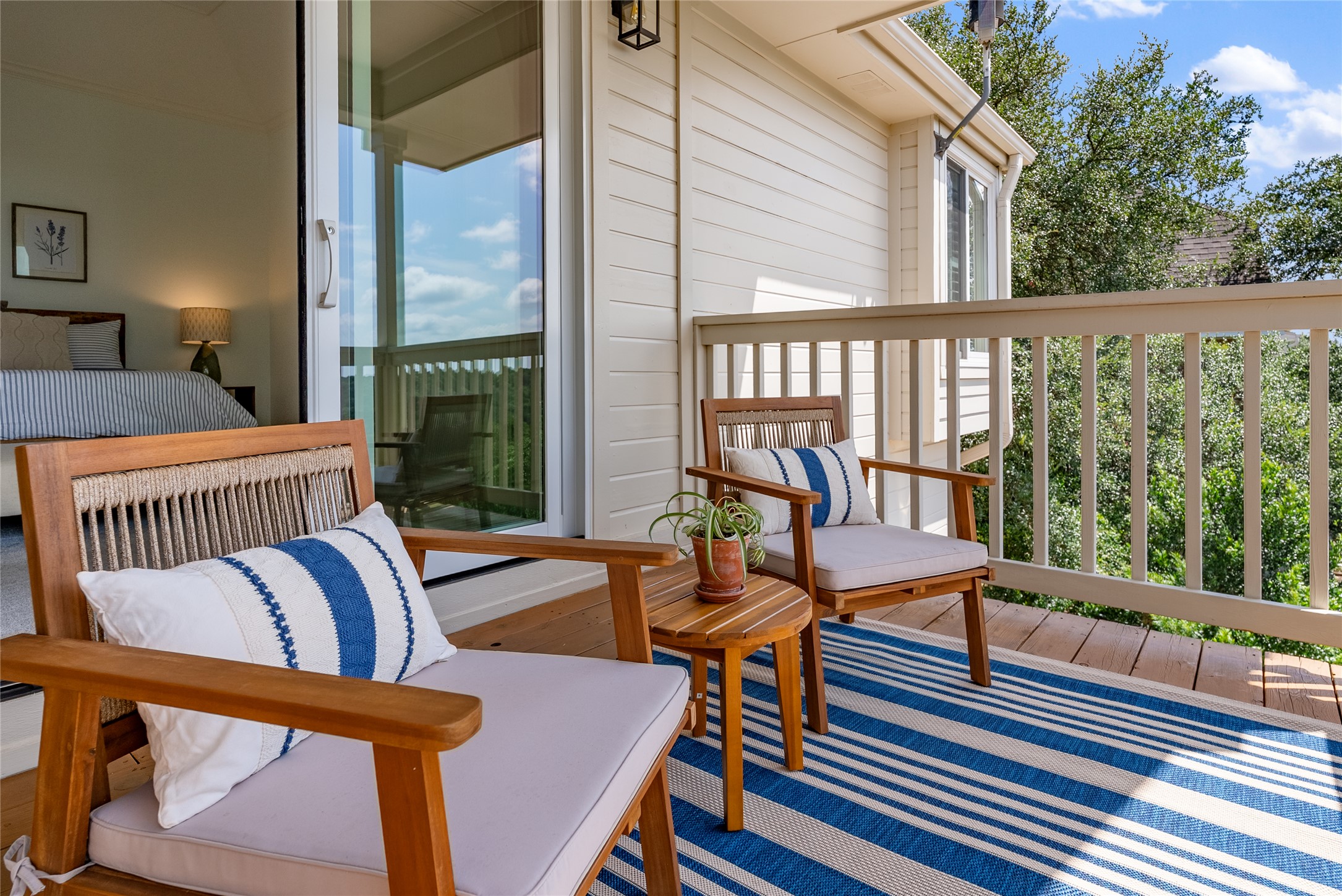 3107 Lookout Lane Austin, TX 78746 - Photo 28 of 39 An inviting balcony space, perfect for tranquil moments, offers direct access to the primary bedroom through glass sliding doors.