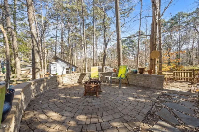 a view of a yard with wooden fence