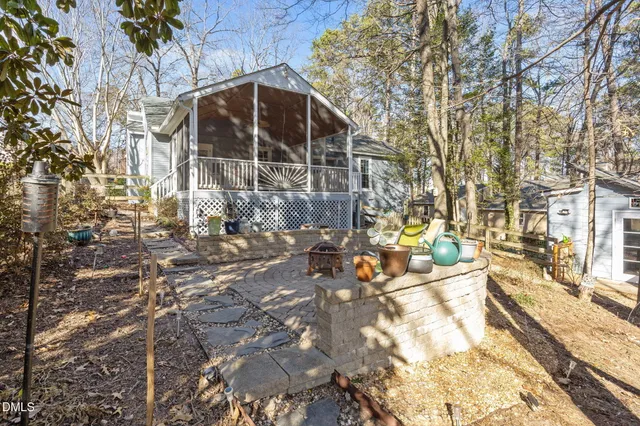 a backyard of a house with table and chairs