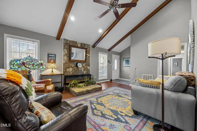 a living room with furniture and wooden floor