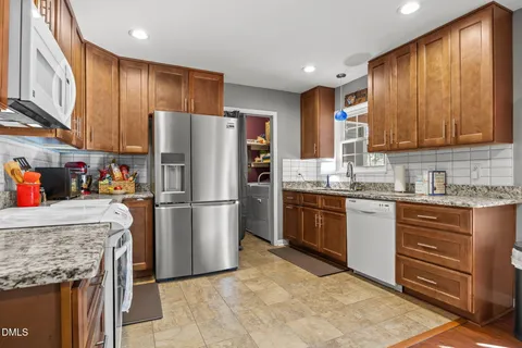a living room with furniture a rug and a flat screen tv