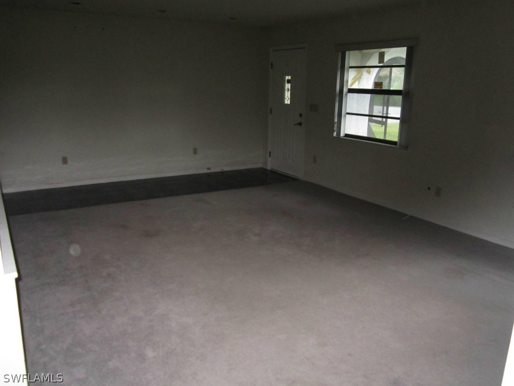 338 Delaware Road Lehigh Acres, FL 33936 - Photo 3 of 11 an empty room with windows