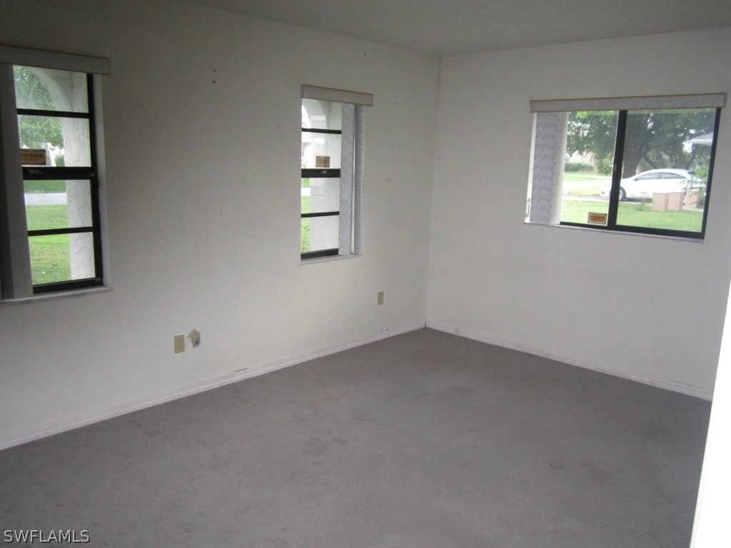 338 Delaware Road Lehigh Acres, FL 33936 - Photo 5 of 11 an empty room with windows