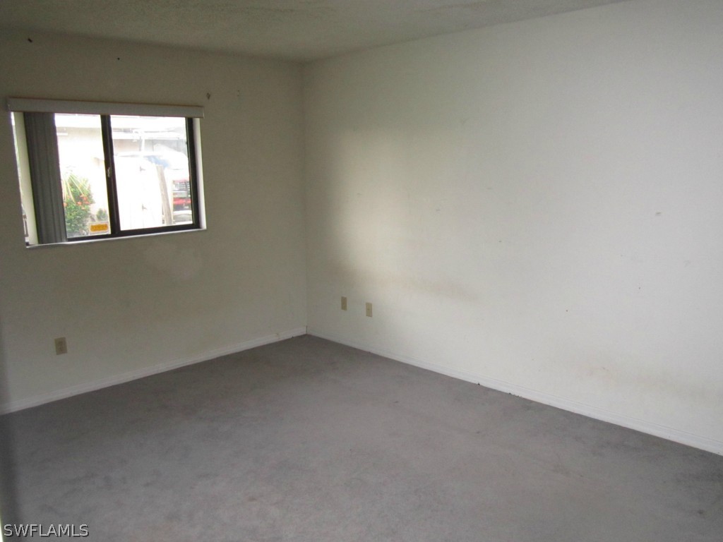 338 Delaware Road Lehigh Acres, FL 33936 - Photo 9 of 11 an empty room with a window