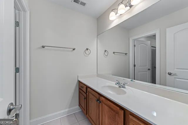 a bathroom with a sink a mirror and a shower