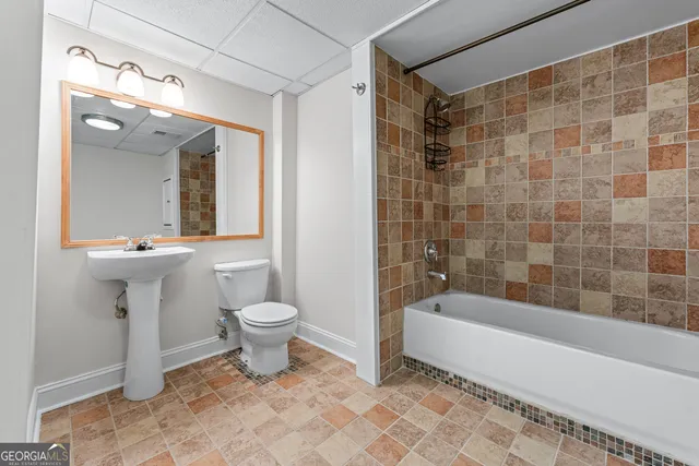 a bathroom with a toilet a sink and bathtub