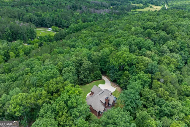 an aerial view of a house with a yard