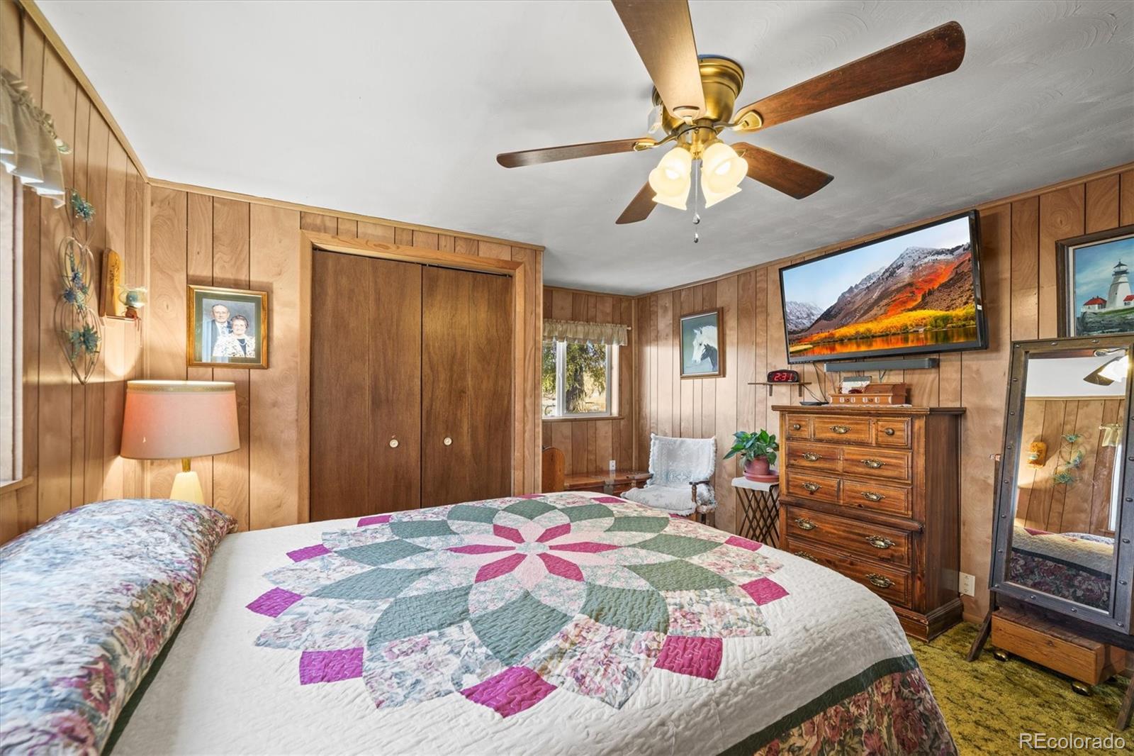577 Main Street Elizabeth, CO 80107 - Photo 20 of 50 a bedroom with a bed and a chandelier