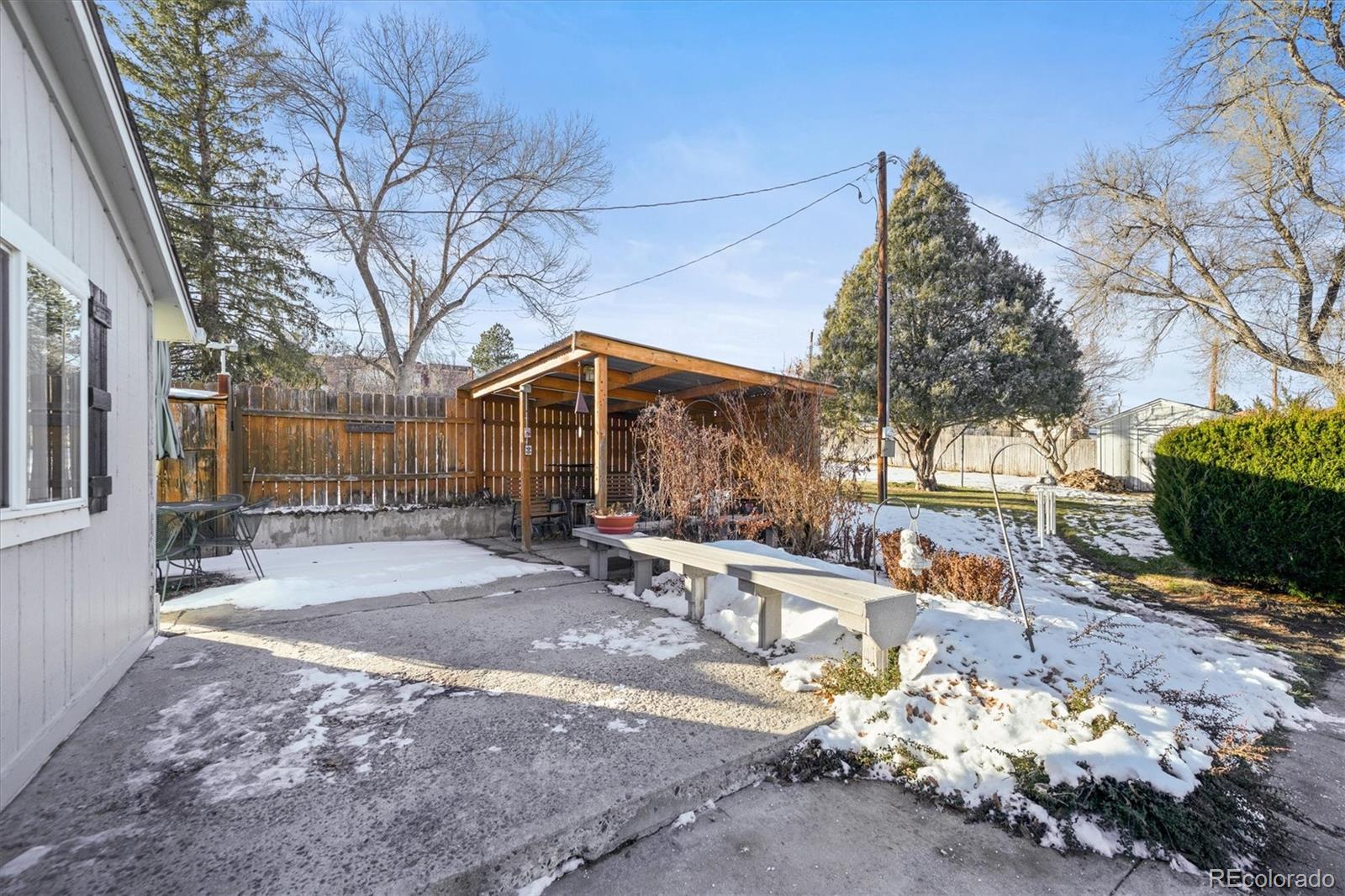 577 Main Street Elizabeth, CO 80107 - Photo 26 of 50 a backyard of a house with large trees and outdoor seating