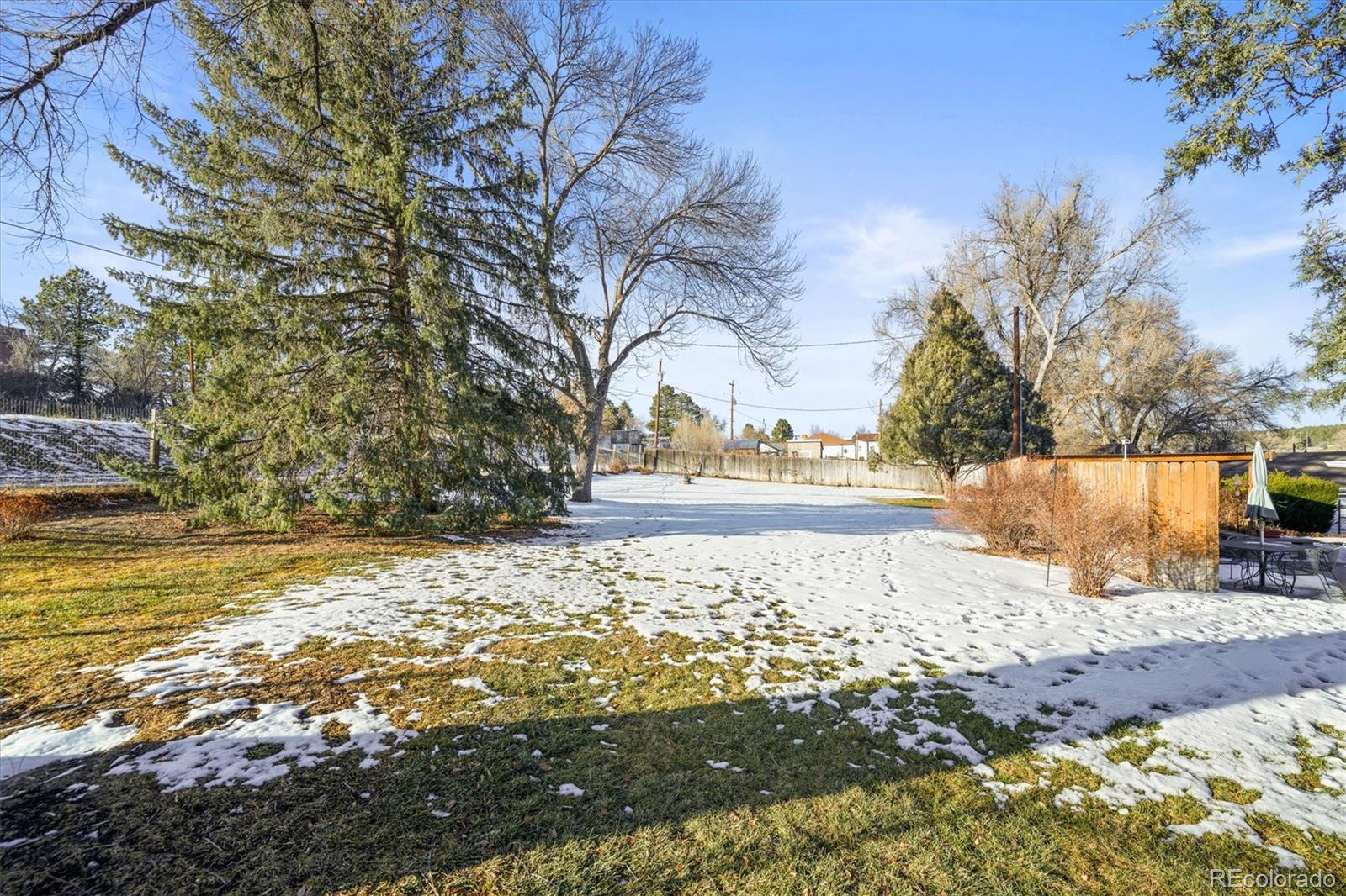 577 Main Street Elizabeth, CO 80107 - Photo 30 of 50 a view of a yard covered with snow in front of house