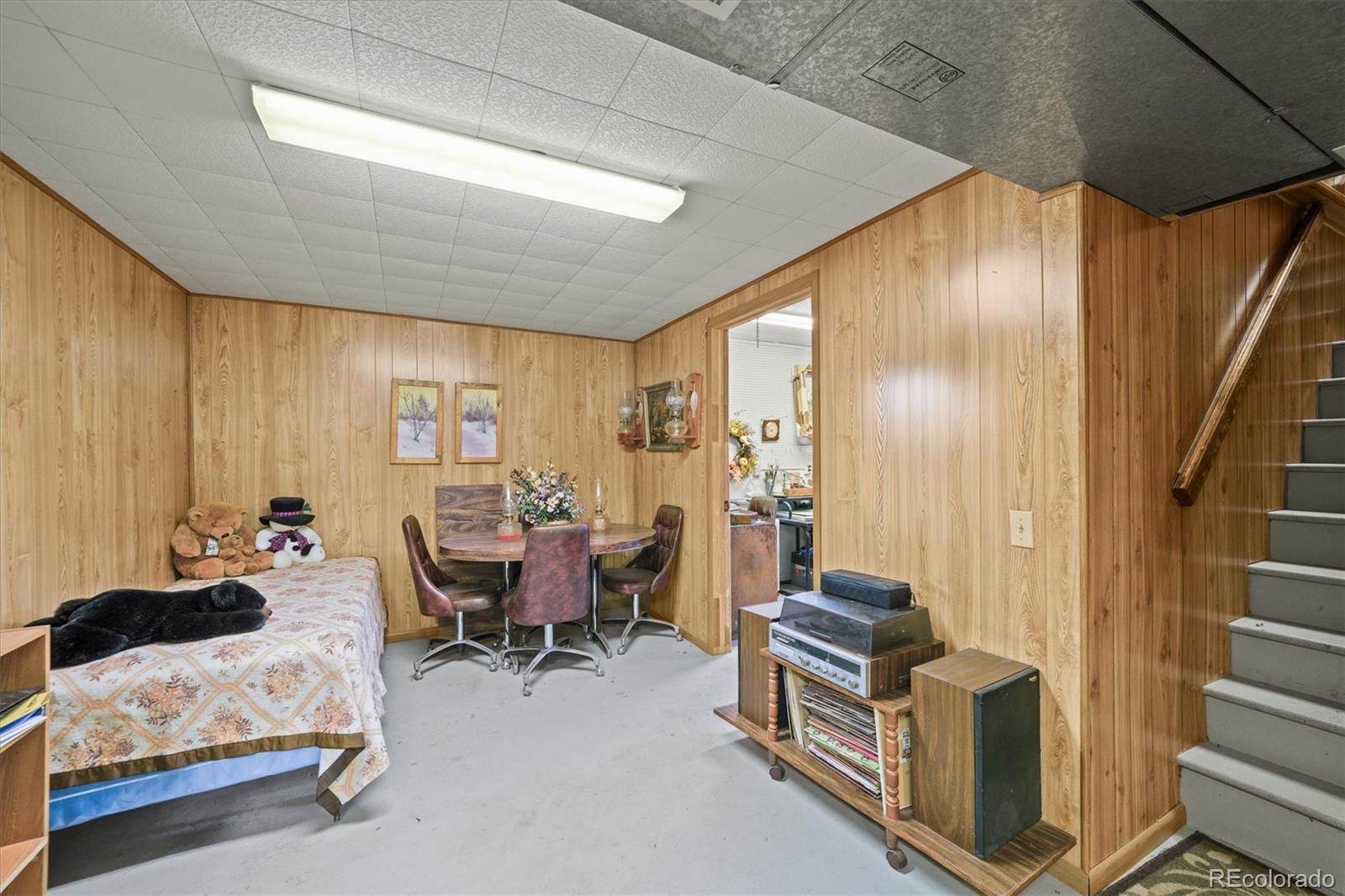577 Main Street Elizabeth, CO 80107 - Photo 32 of 50 a bedroom with furniture and wooden floor