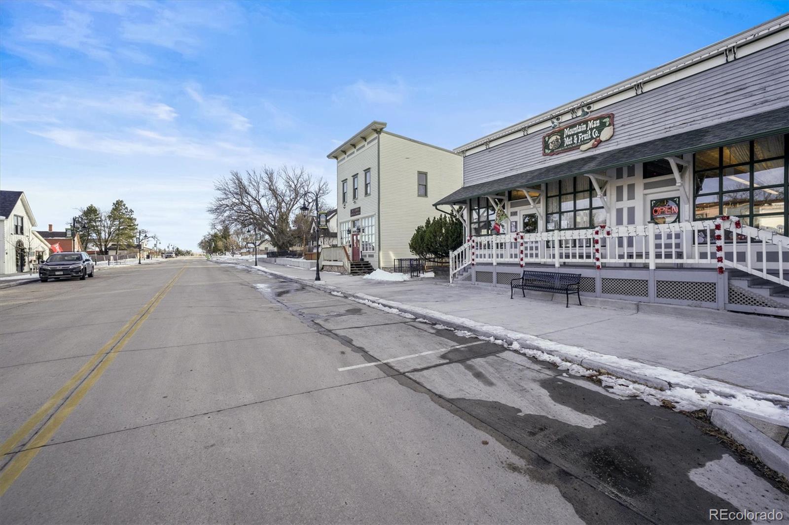 577 Main Street Elizabeth, CO 80107 - Photo 46 of 50 a front view of a building with glass windows and palm trees