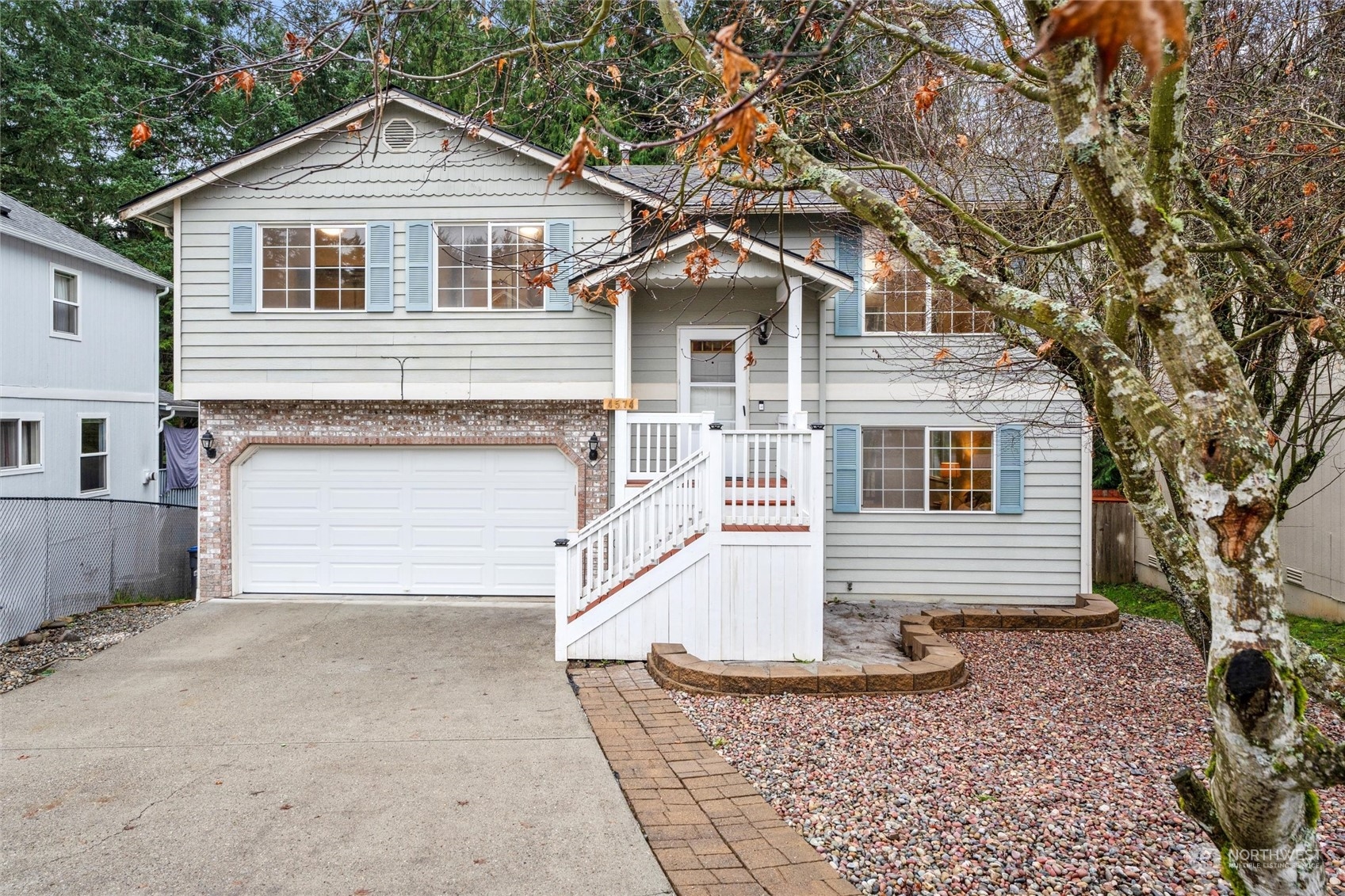 4574 Knute Anderson Road Northwest Silverdale, WA 98383 - Photo 1 of 39 a front view of a house with a yard and garage