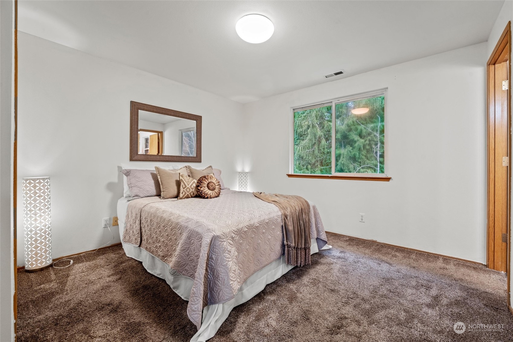 4574 Knute Anderson Road Northwest Silverdale, WA 98383 - Photo 14 of 39 a bed room with a bed and a painting
