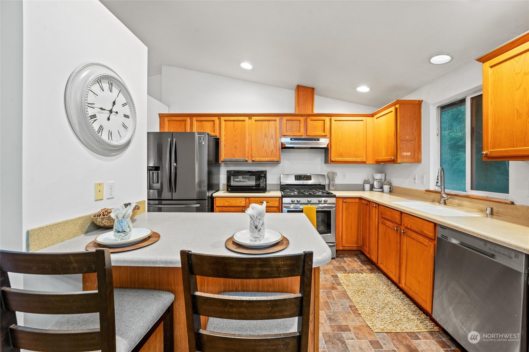 4574 Knute Anderson Road Northwest Silverdale, WA 98383 - Photo 29 of 39 a large kitchen with a table chairs and a view of living room