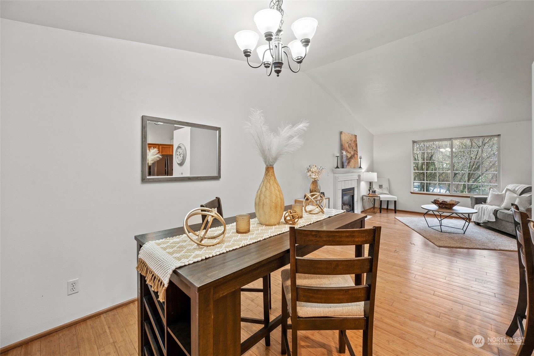 4574 Knute Anderson Road Northwest Silverdale, WA 98383 - Photo 33 of 39 a view of a dining room with furniture a chandelier and wooden floor