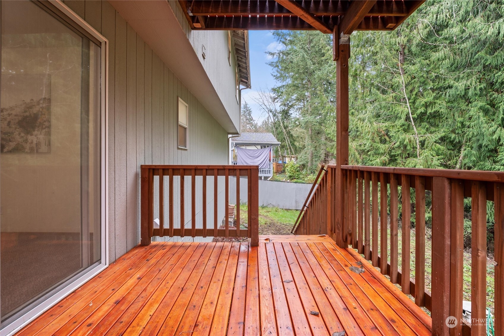 4574 Knute Anderson Road Northwest Silverdale, WA 98383 - Photo 36 of 39 a balcony with wooden floor in front of a house