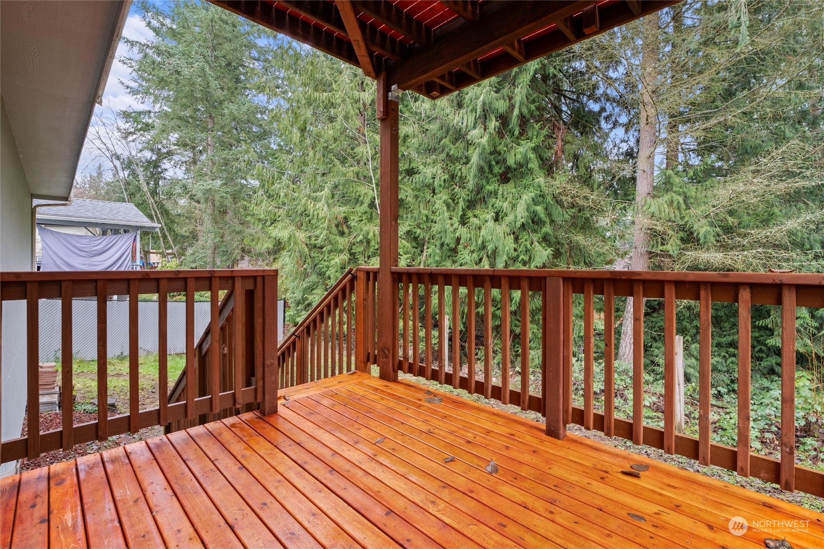 4574 Knute Anderson Road Northwest Silverdale, WA 98383 - Photo 37 of 39 a balcony with wooden floor and outdoor space