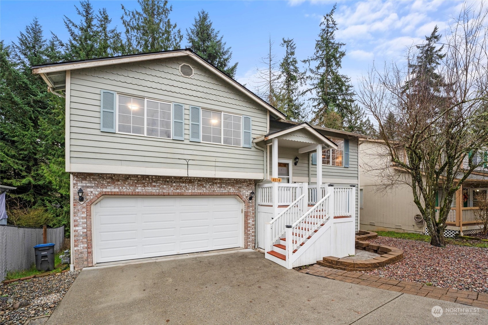 4574 Knute Anderson Road Northwest Silverdale, WA 98383 - Photo 4 of 39 a front view of a house with a garage