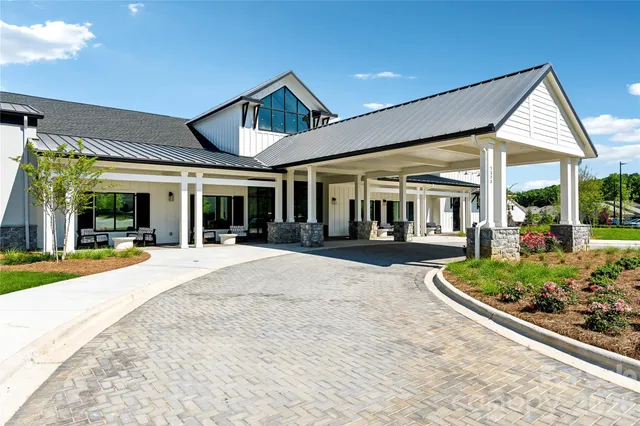 a swimming pool with yard in front of it