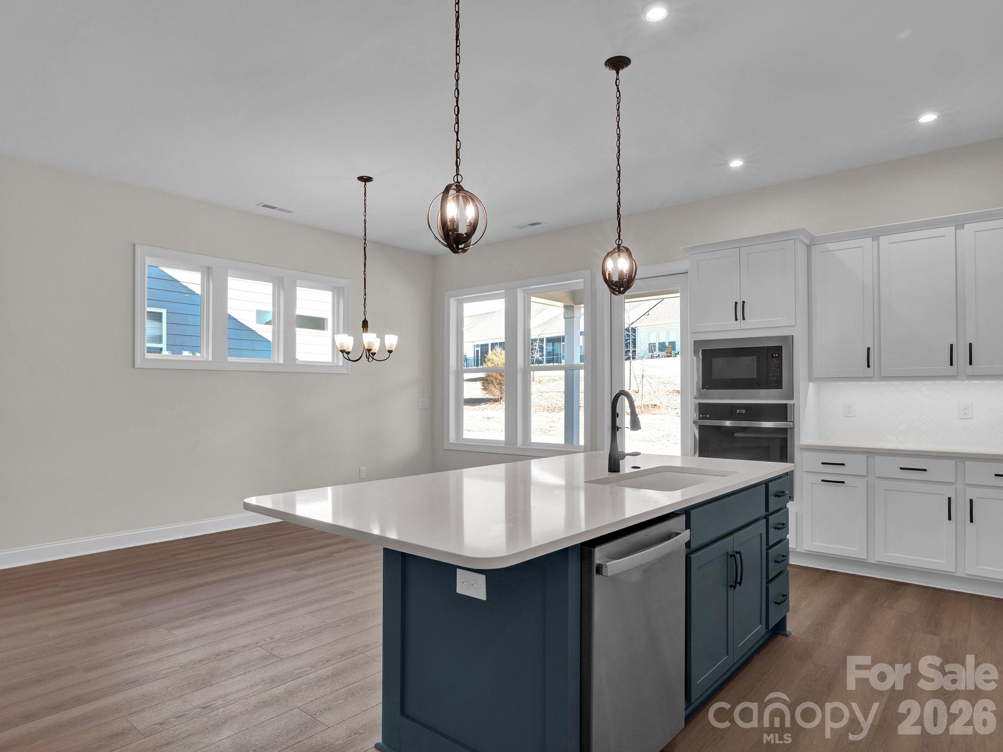 3031 Lake Como Drive Monroe, NC 28110 - Photo 6 of 39 a kitchen with center island and wooden floor