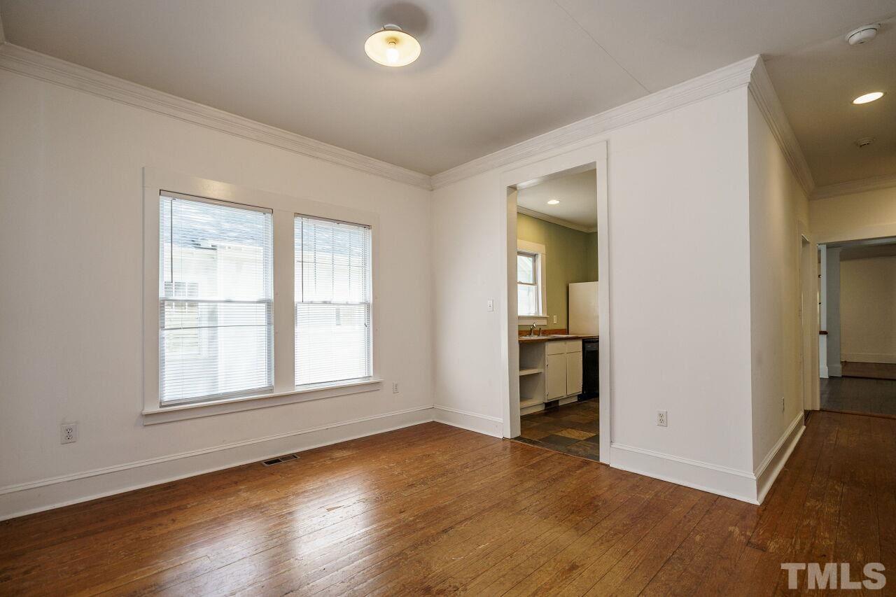 105 East Whitaker Mill Road Raleigh, NC 27608 - Photo 14 of 21 an empty room with wooden floor and windows