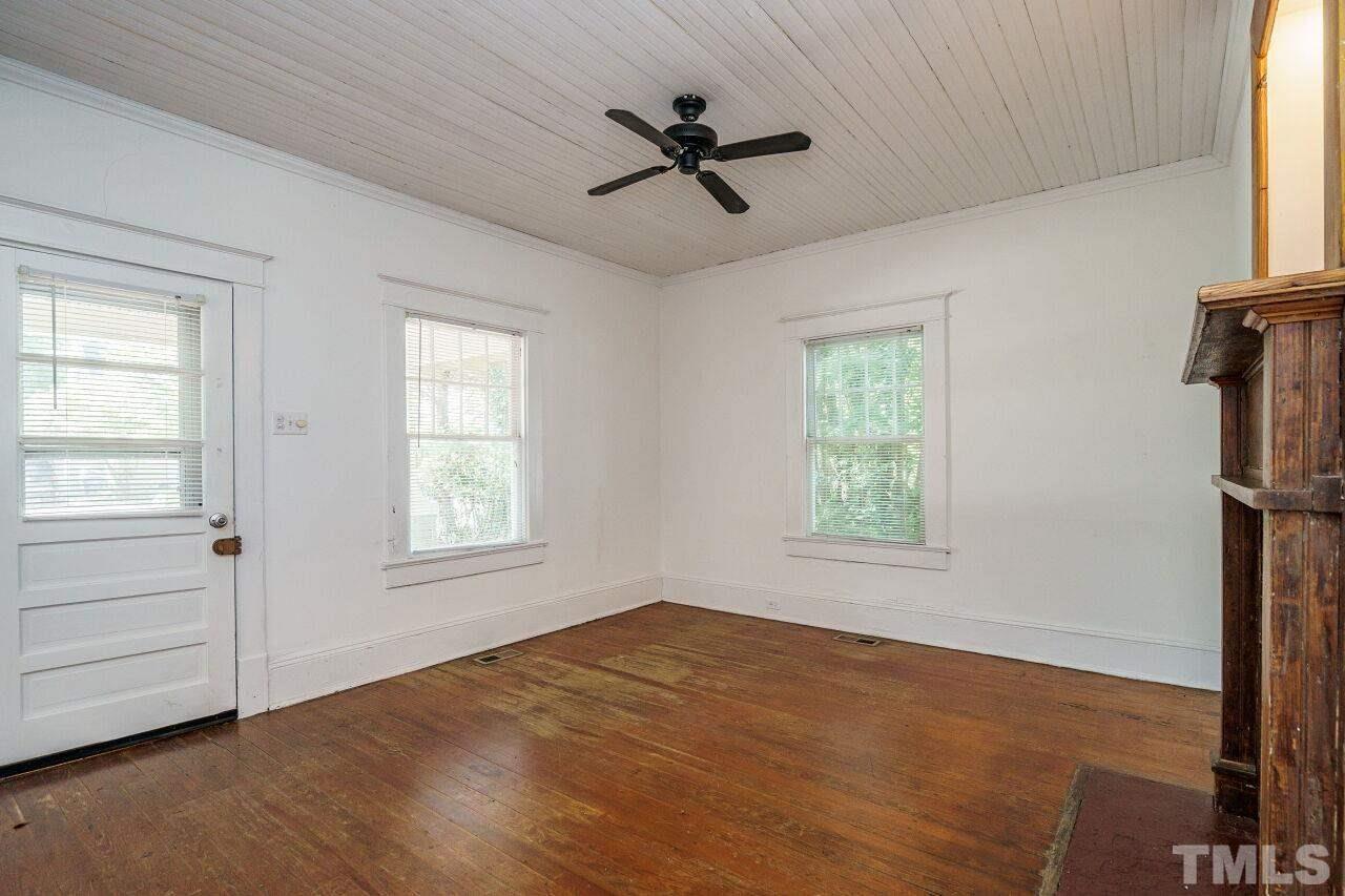 105 East Whitaker Mill Road Raleigh, NC 27608 - Photo 4 of 21 a view of empty room with wooden floor and fan
