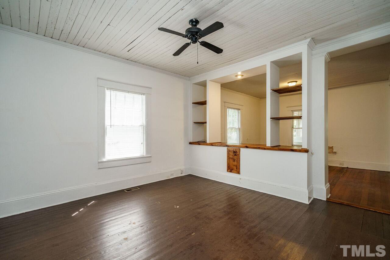 105 East Whitaker Mill Road Raleigh, NC 27608 - Photo 8 of 21 an empty room with wooden floor and windows