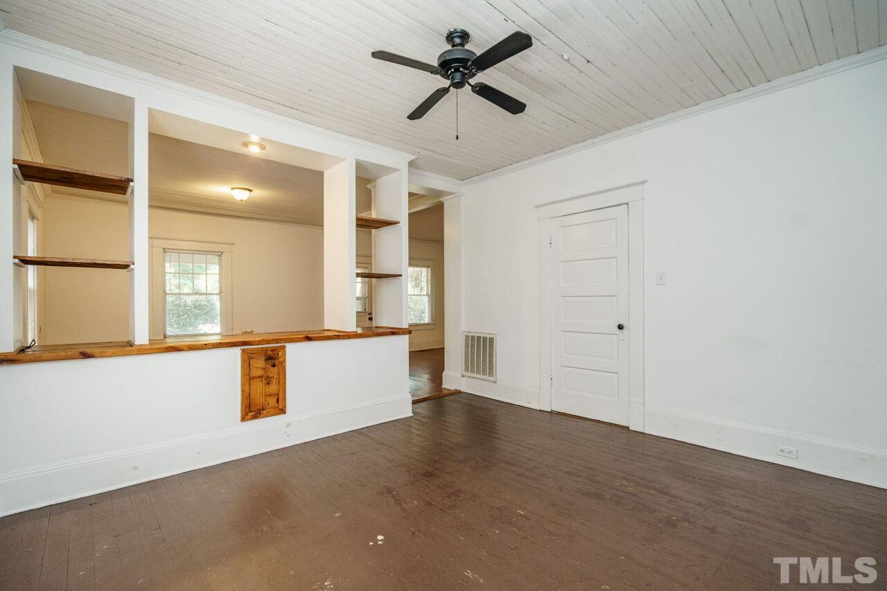 105 East Whitaker Mill Road Raleigh, NC 27608 - Photo 9 of 21 wooden floor in an empty room with a window