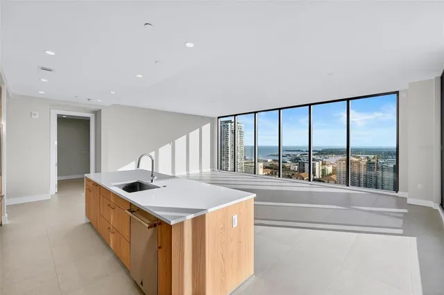 a bathroom with a granite countertop sink a toilet and shower