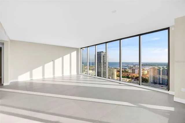 a bedroom with a large bed and a large window