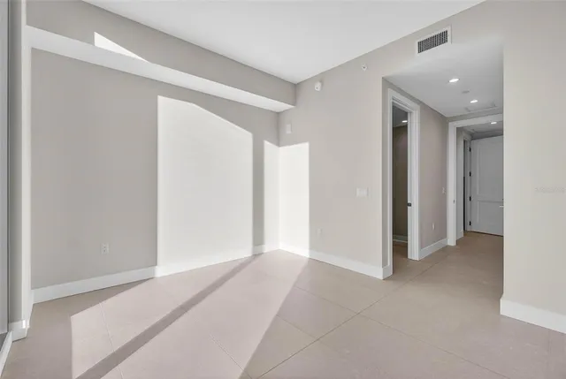 an empty room with windows and city view