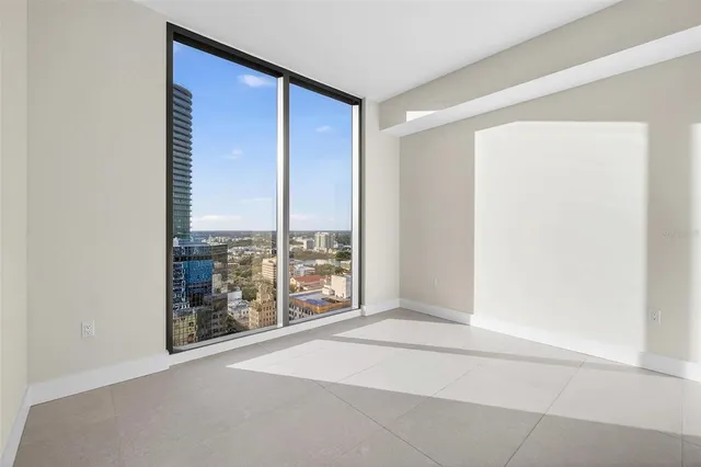 a living room with furniture a flat screen tv and potted plant