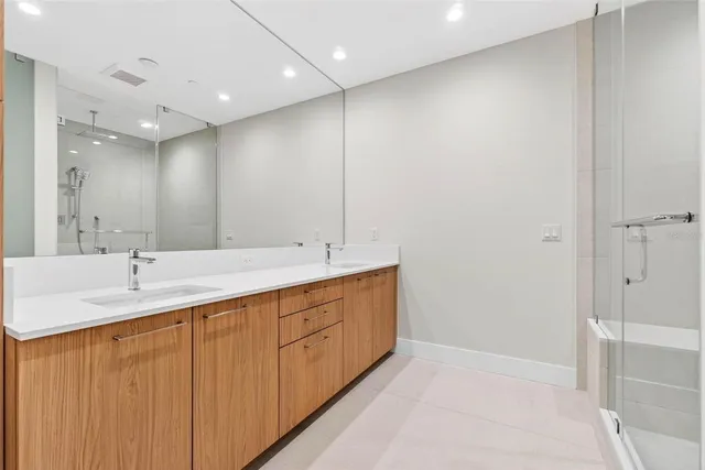 a view of a patio with a dining table and chairs under an umbrella with a fire pit