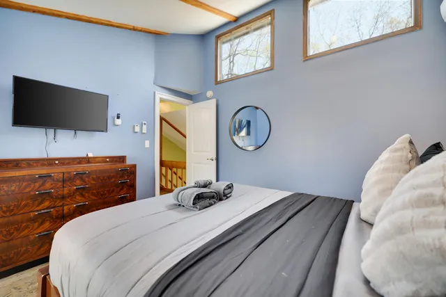 a bed sitting in a bedroom next to a window