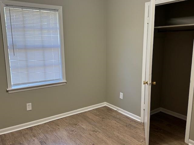 3245 Sinclair Street Memphis, TN 38127 - Photo 12 of 28 Unfurnished bedroom featuring multiple windows, a closet, and hardwood / wood-style flooring