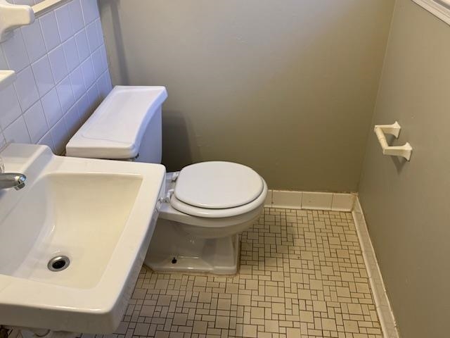 3245 Sinclair Street Memphis, TN 38127 - Photo 14 of 28 Bathroom with tile walls, tile patterned flooring, toilet, and sink