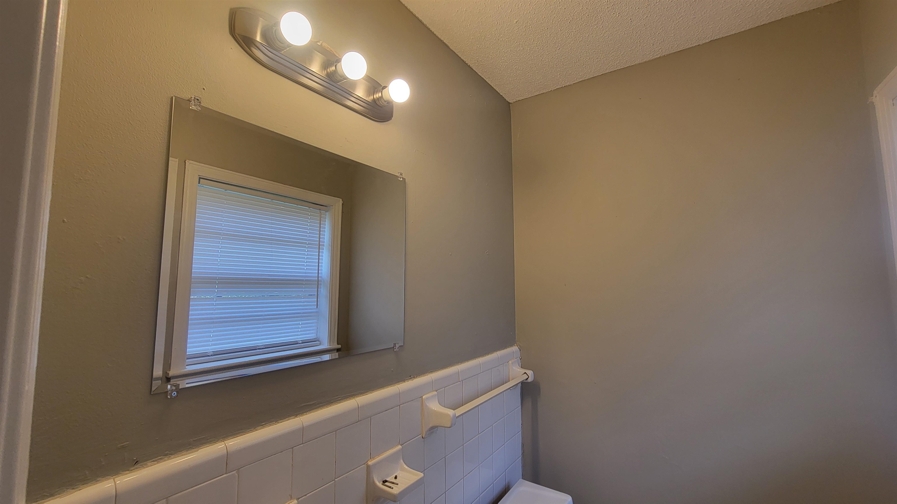 3245 Sinclair Street Memphis, TN 38127 - Photo 15 of 28 Bathroom featuring tile walls and a textured ceiling