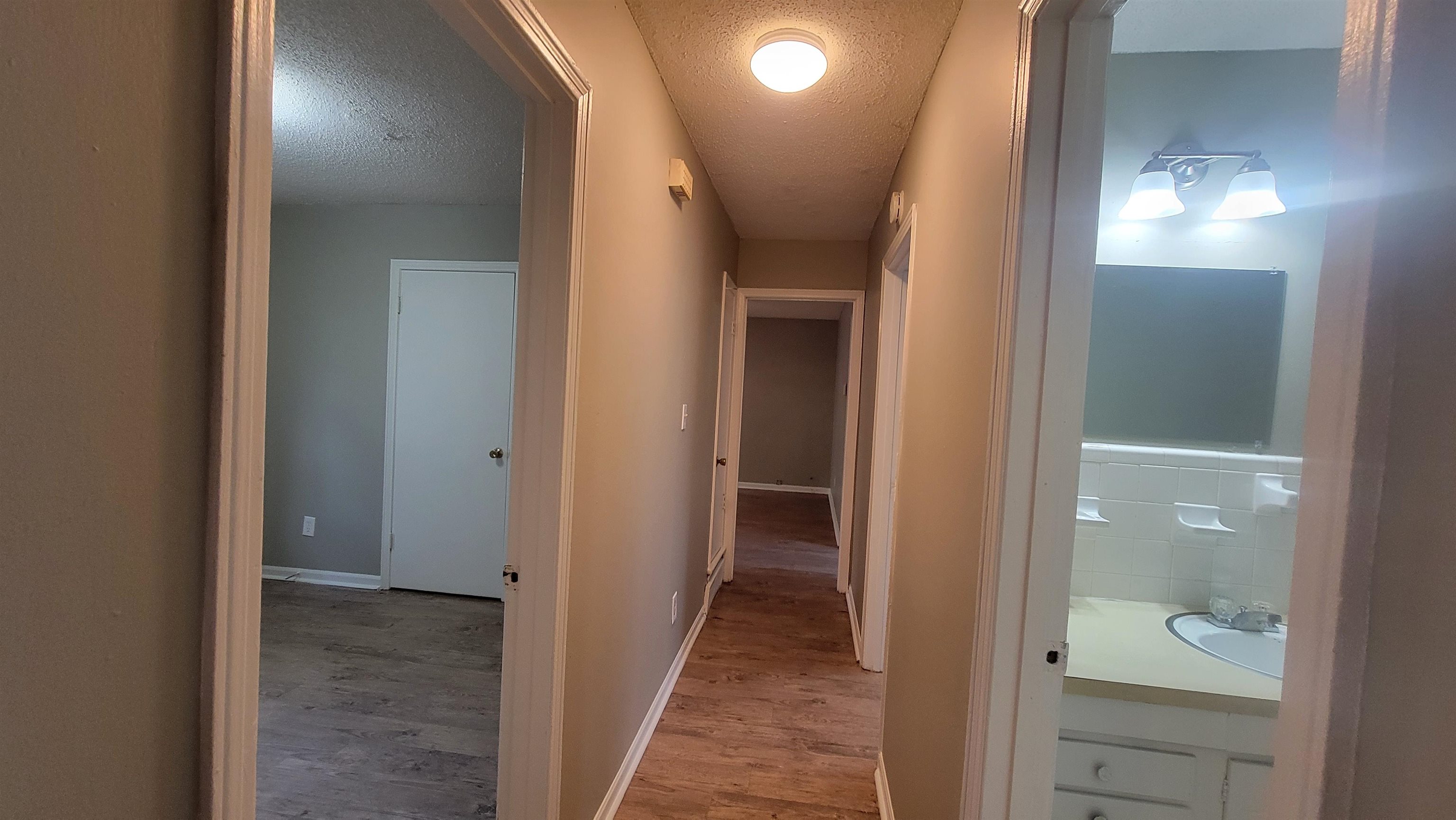 3245 Sinclair Street Memphis, TN 38127 - Photo 18 of 28 Corridor featuring a textured ceiling and hardwood / wood-style flooring