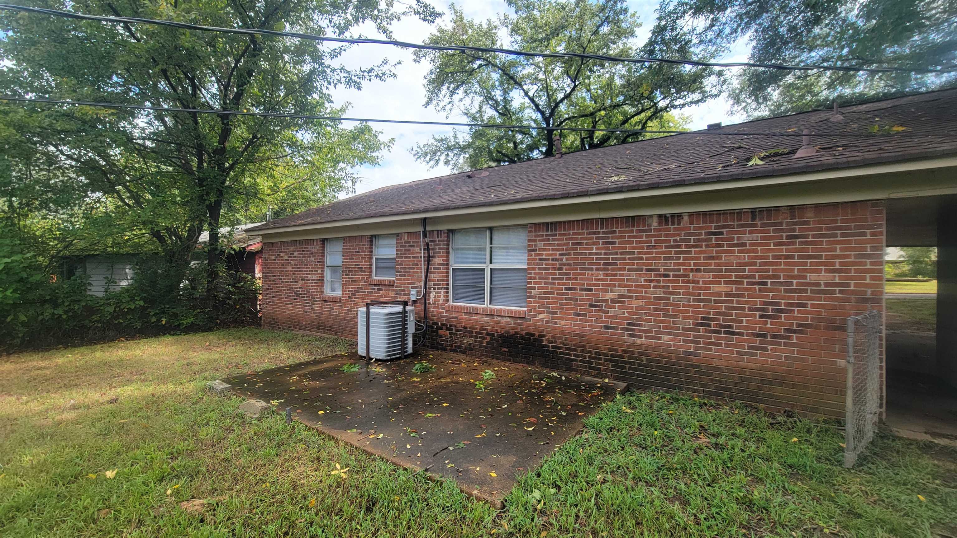 3245 Sinclair Street Memphis, TN 38127 - Photo 24 of 28 View of home's exterior featuring central air condition unit, a yard, and a patio