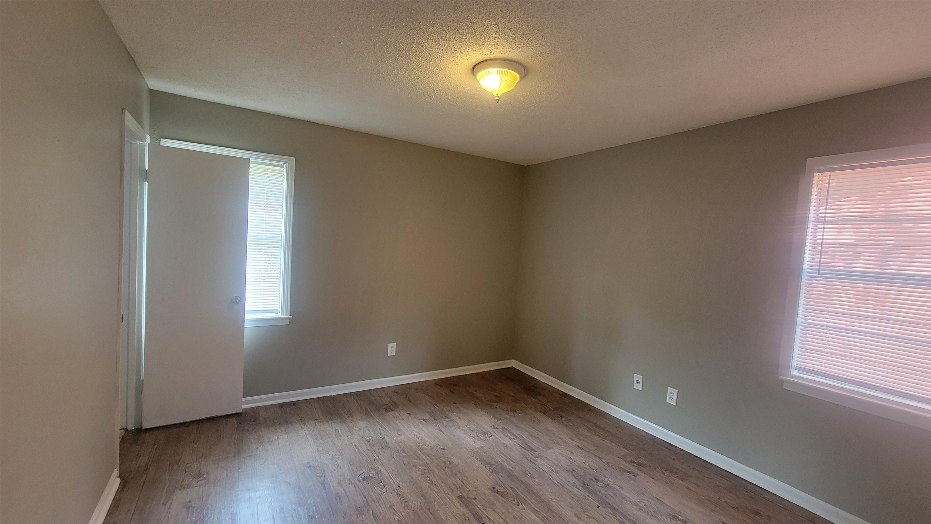 3245 Sinclair Street Memphis, TN 38127 - Photo 9 of 28 Unfurnished room with light hardwood / wood-style flooring and a textured ceiling