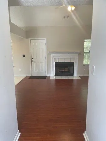 a view of livingroom with fireplace cabinet and window