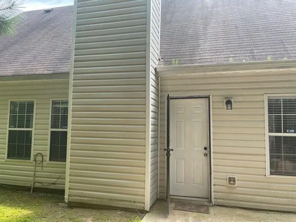 a view of a yard with wooden fence