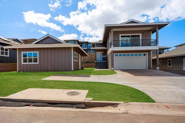 a front view of a house with a yard and garage