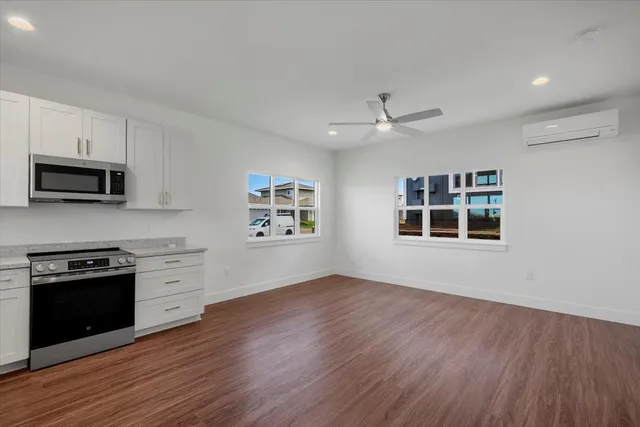 a kitchen with granite countertop a refrigerator oven a sink and dishwasher