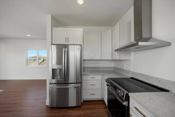 a kitchen with stainless steel appliances granite countertop a sink stove and cabinets